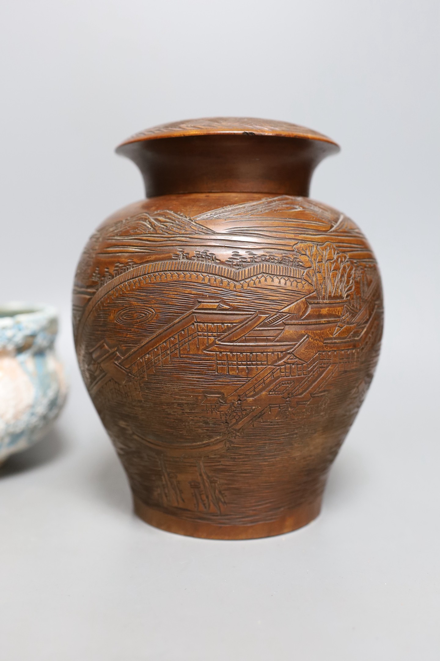 Two Japanese stoneware tea bowls (chawan), a Japanese raku bowl and a Japanese carved wood tea caddy, 19cm